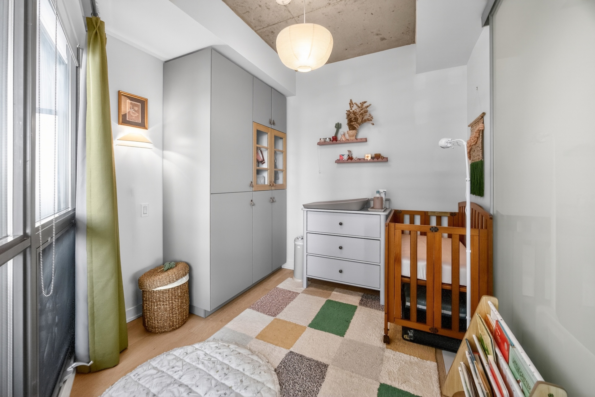 Second bedroom nursery with grey wardrobes, changing table and crib