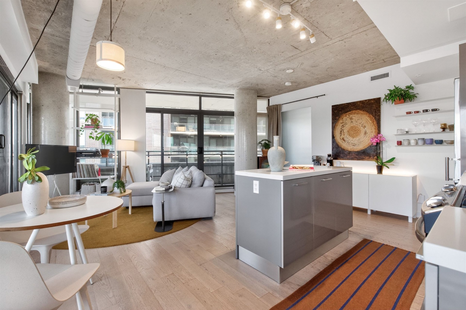 Open kitchen with living area and balcony view