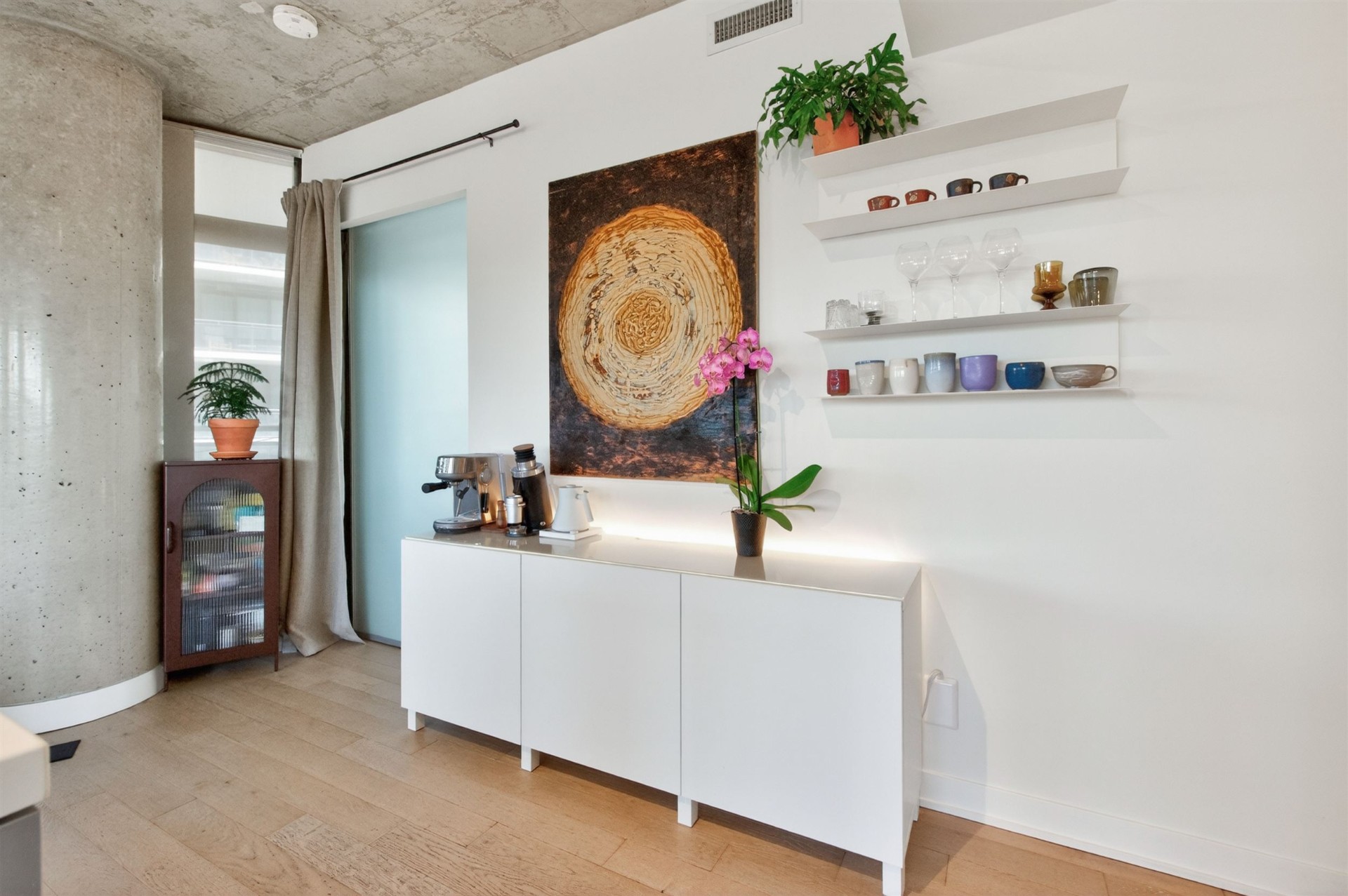 Coffee bar nook with floating shelves and artwork