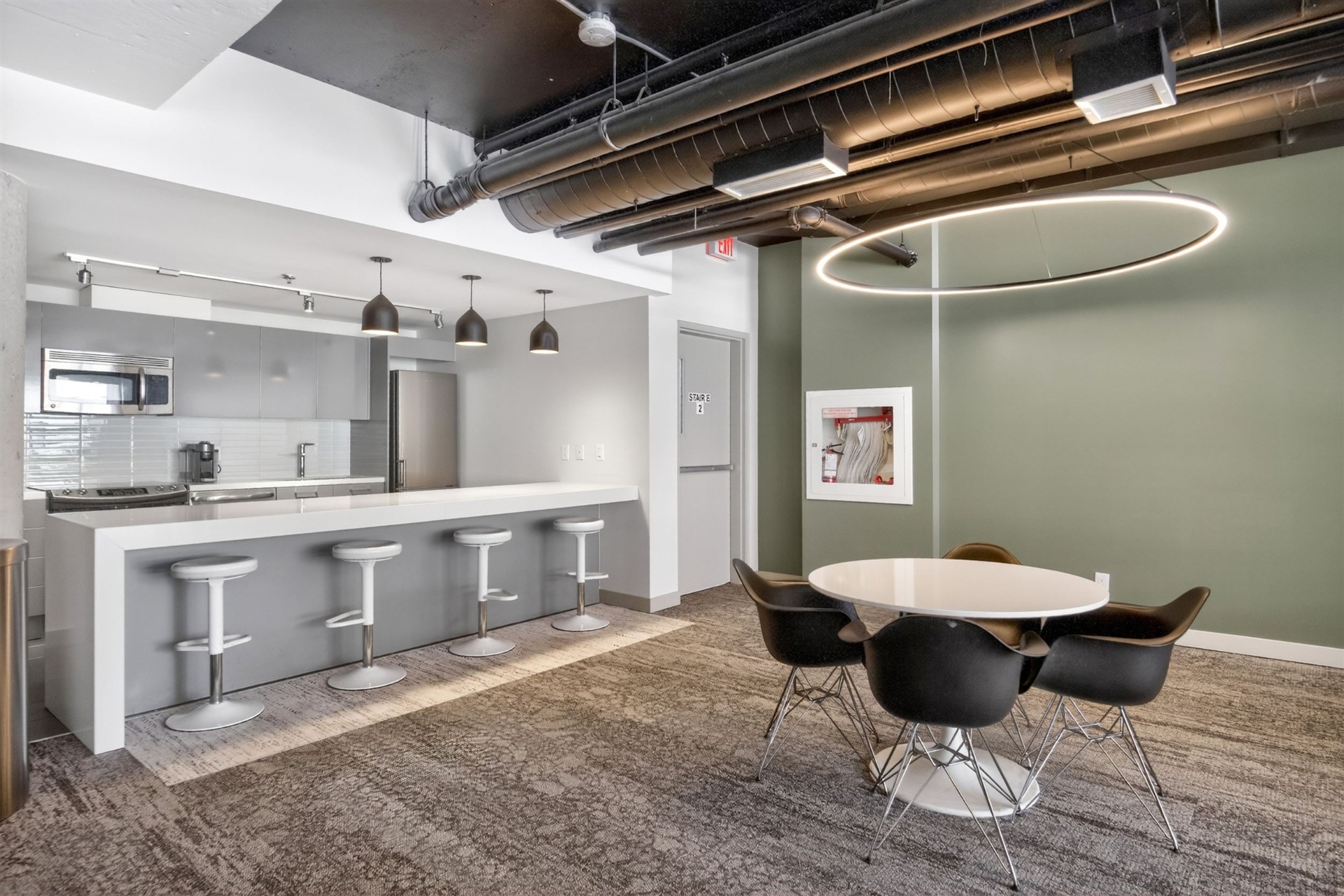 Amenity lounge kitchen with breakfast bar and dining area