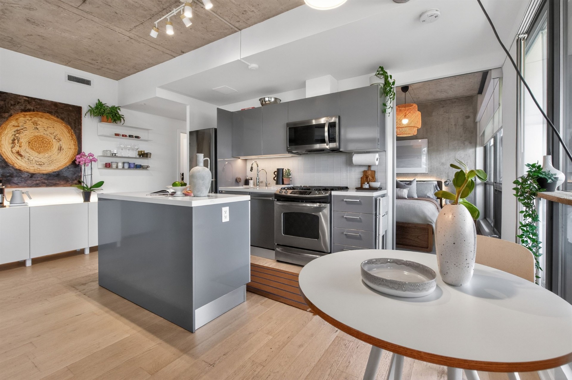 Dining nook beside kitchen with concrete ceiling