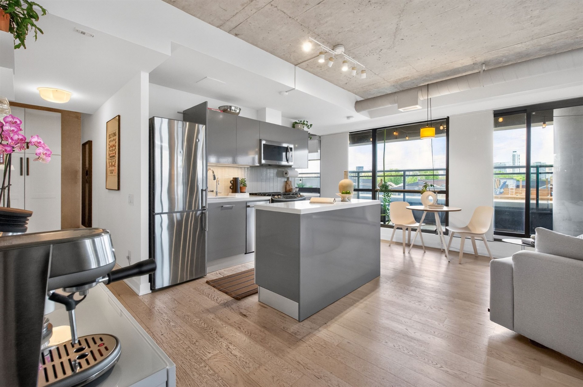 Kitchen island and dining area with floor-to-ceiling windows
