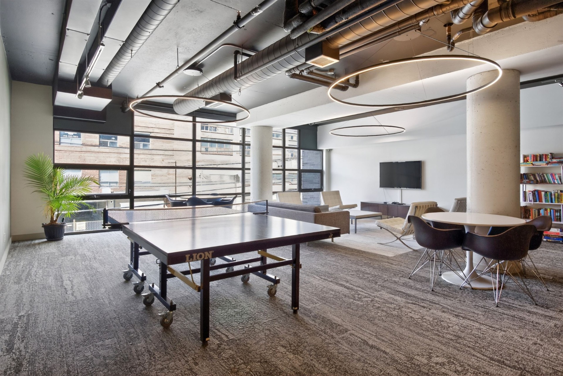 Amenity room with ping pong table, lounge seating and library