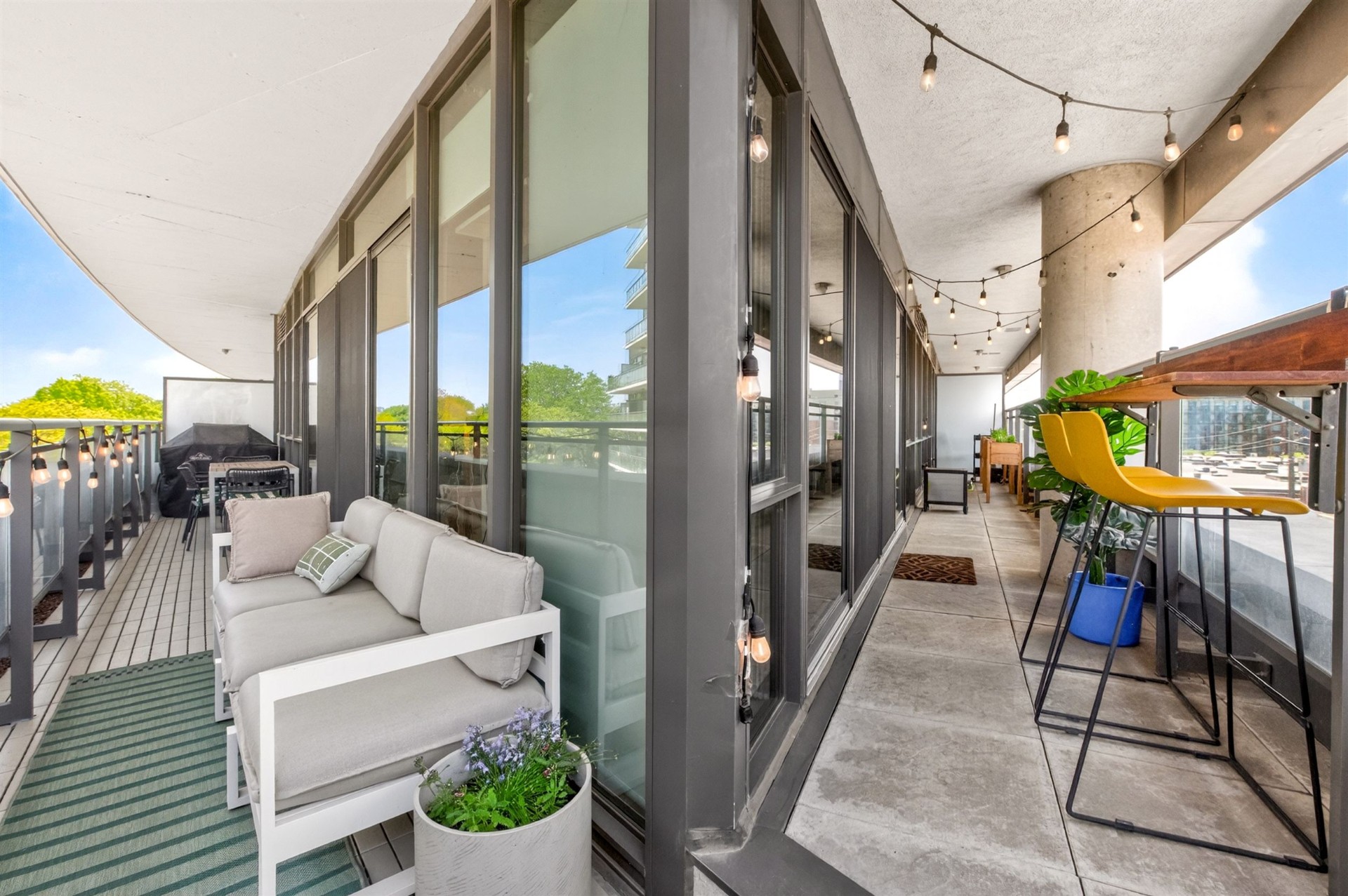 Terrace lounge area with sofa and bar seating
