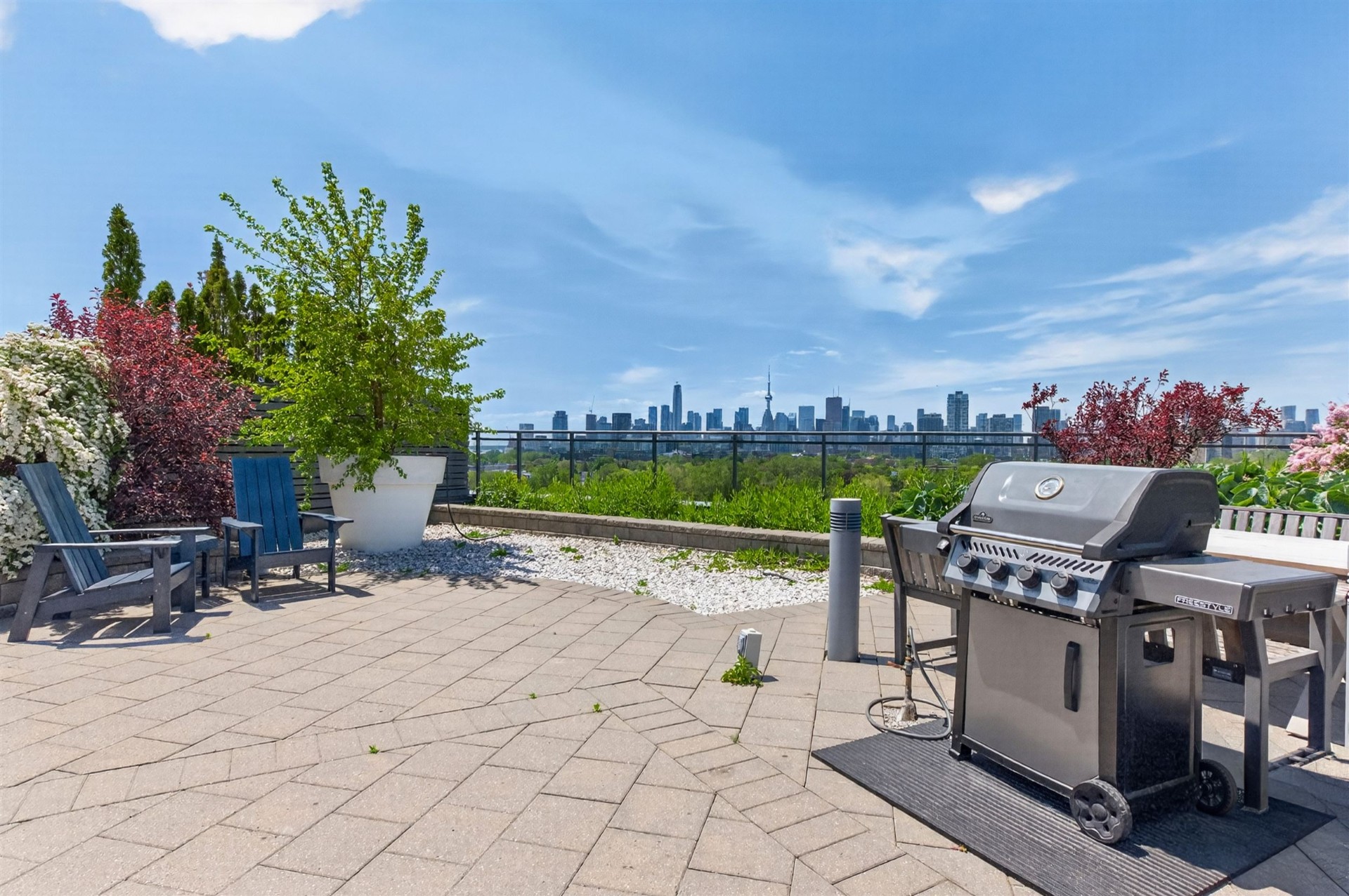 Rooftop terrace with Adirondack chairs and Toronto skyline view