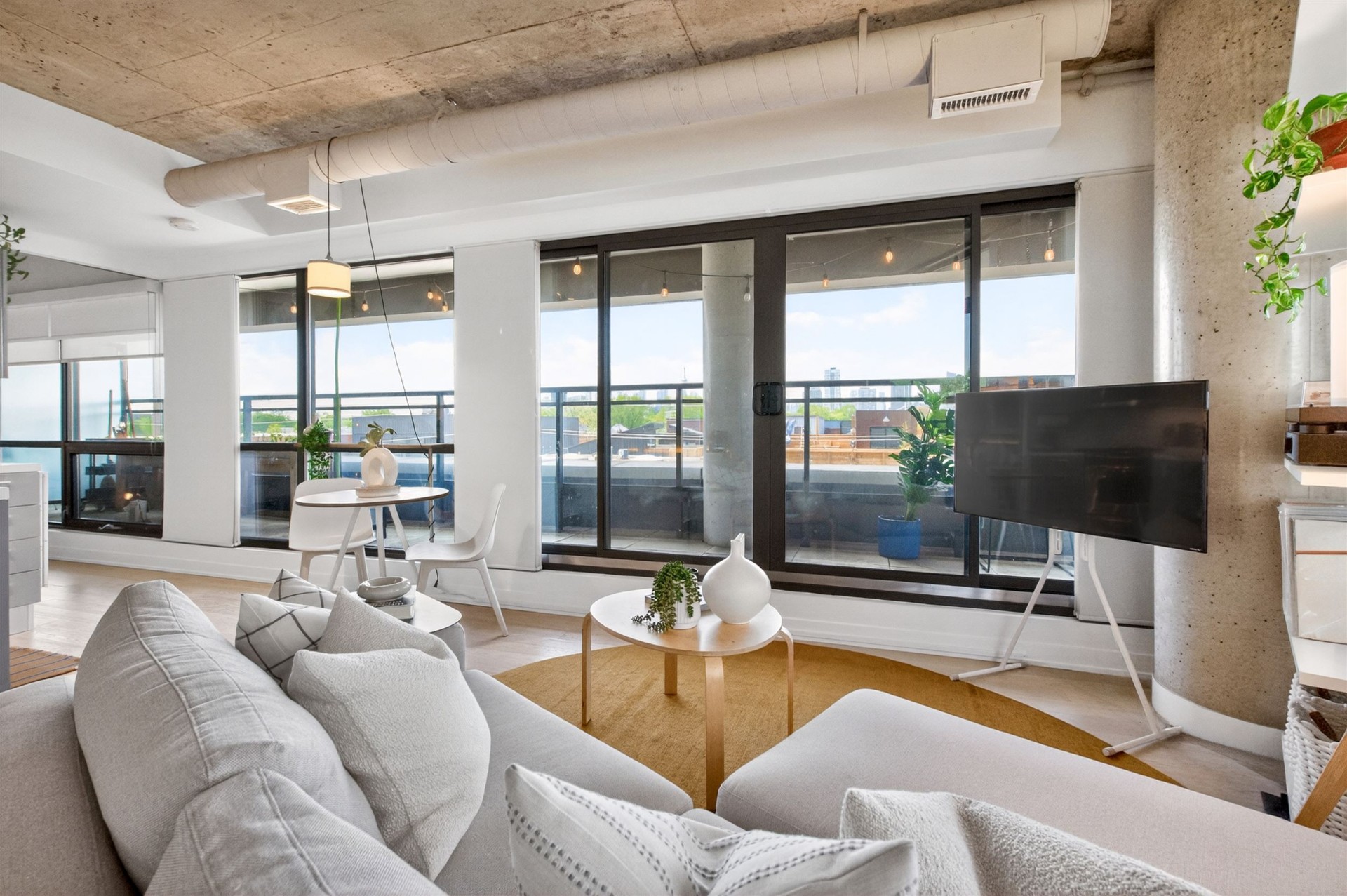 Living room with terrace doors and exposed concrete ceiling