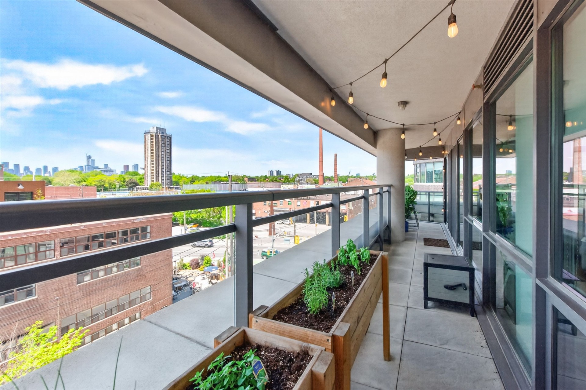 Wrap-around terrace with herb planters and skyline view