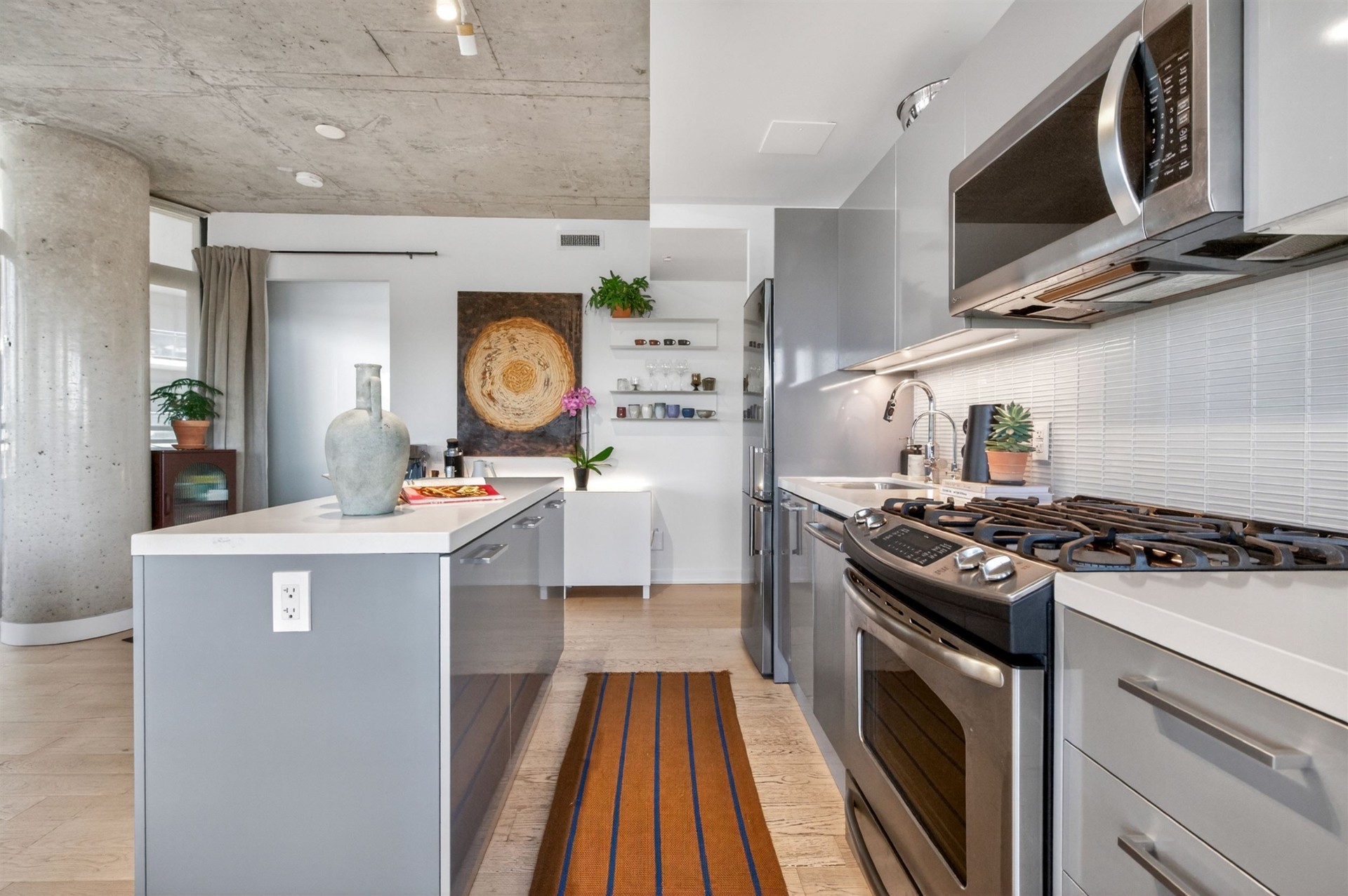 Galley kitchen with gas range and stainless appliances