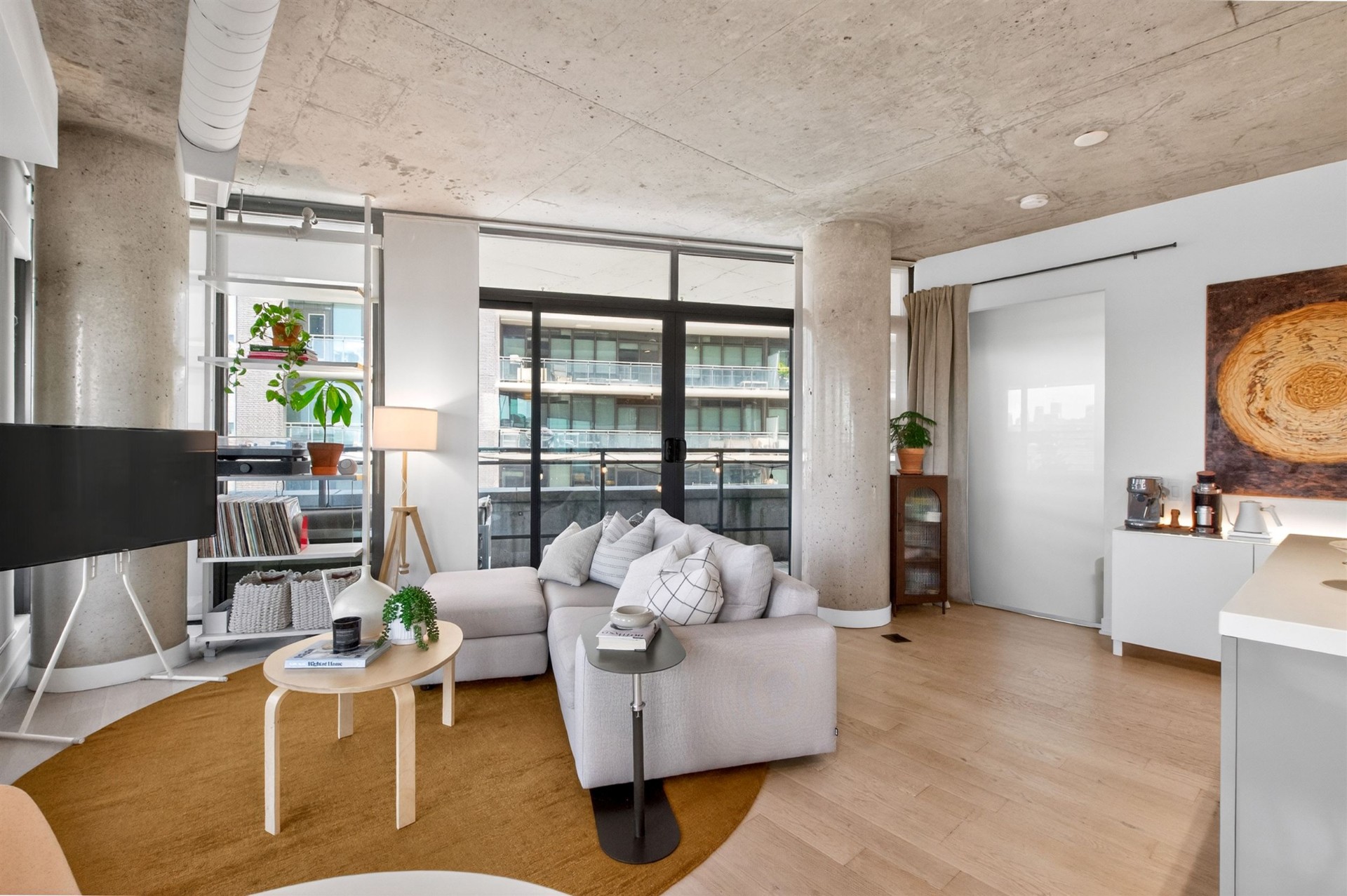 Spacious living area with concrete columns and balcony