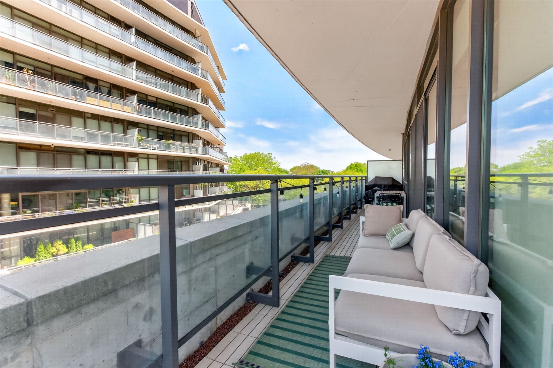 Terrace lounge with treetop views and neighbouring tower