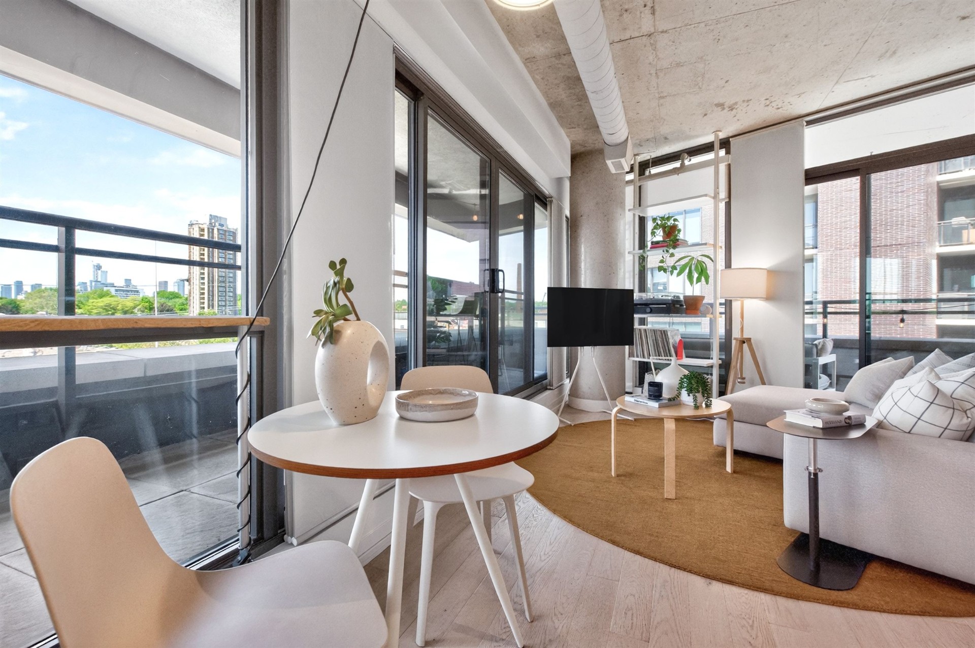 Dining area with floor-to-ceiling windows and skyline view